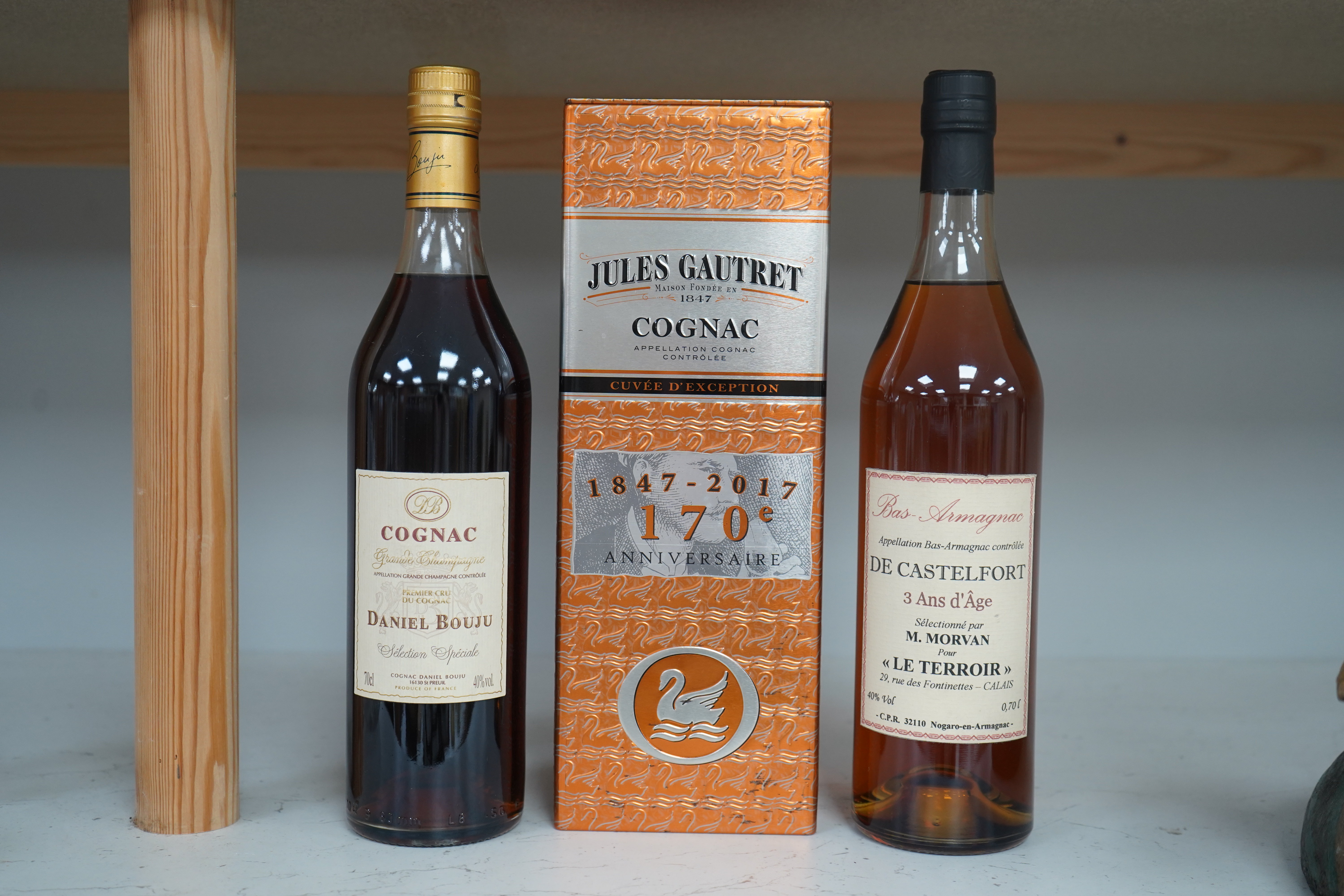 Three bottles of cognac/armagnac - a cased bottle of Jules Gautret 170th anniversary cognac, a bottle of Daniel Bouju Selection Speciale Grand Champagne Cognac and a bottle of De Castelfort Bas Armagnac. Condition - good